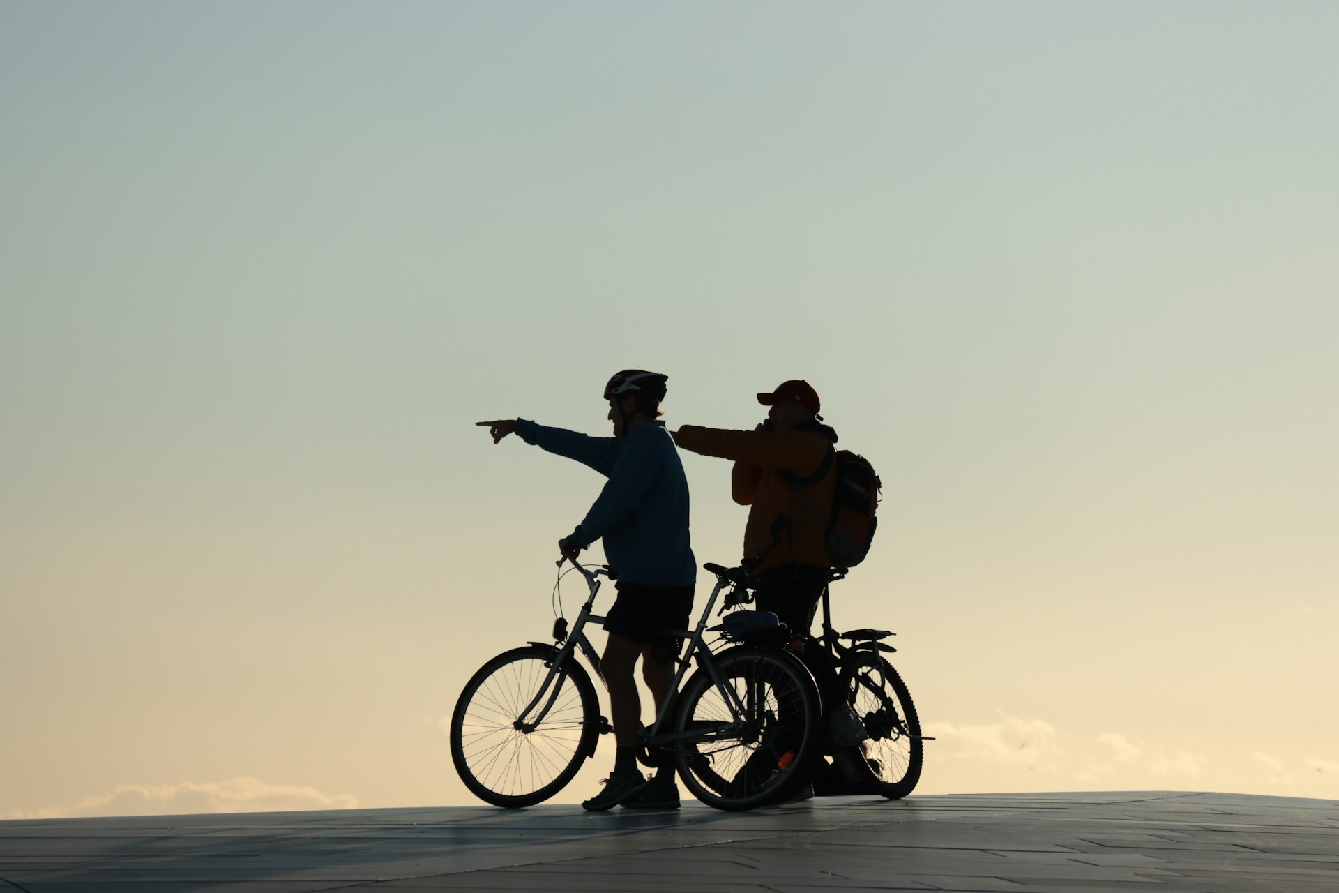 Cyclist pointing in a direction in shadow in Norway